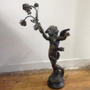 After Auguste Moreau, a late 19th century spelter figural lamp, modelled as Cupid, standing with