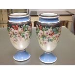 A pair of large Victorian painted opaque glass vases, of baluster form, each with white metal rim,