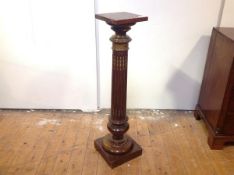 A gilt-metal mounted walnut columnar pedestal, the square top over a fluted column, on a baluster