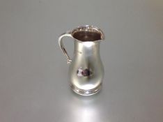 A George V heavy gauge silver cream jug, Thomas Bradbury & Sons, Sheffield 1913, of elongated