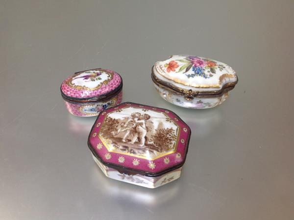 A group of three Continental porcelain table boxes, 19th century and later, the first of shaped oval