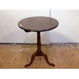 A George III mahogany tilt-top mahogany tripod table, the circular top on a ring-turned tapering