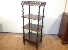 A Victorian mahogany four tier whatnot, of rectangular shape, the top with a fret-carved three-