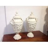 A pair of large composition urns in the Neoclassical taste, each stepped domed cover with berry