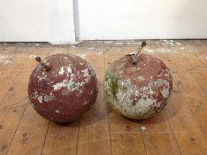 A pair of large weathered red sandstone ball finials, c. 1900. Diameter 24cm