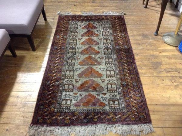 A silk and cotton mix Caucasian rug, the central triangle with stylised peacock, lotus flower and
