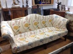 A George III mahogany framed camel back sofa, c. 1800, of characteristic form, the stuffed over seat