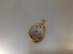 An early 20th century 9ct gold double-sided pendant locket, the oval glazed apertures enclosing