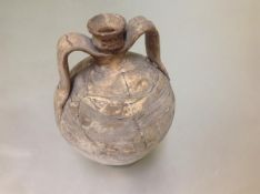 An excavated pottery twin-handled urn, possibly Romano-British, of amphora shape, with strap handles