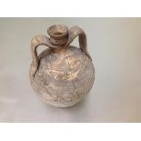 An excavated pottery twin-handled urn, possibly Romano-British, of amphora shape, with strap handles