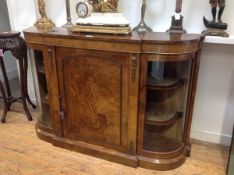 A Victorian inlaid walnut credenza, the projecting central section between bowed ends, each with a