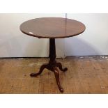 A George III mahogany tripod table, the circular top raised on a handsome fluted columnar standard