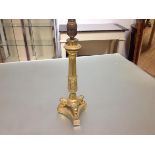 An Empire style gilt-bronze candlestick, converted to a table lamp, the fluted column cast with a