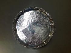 A George III silver waiter, maker I.C, London 1775, circular, with beaded scalloped rim, the well