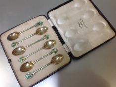 A cased set of six George V silver-gilt and enamel teaspoons, Turner & Simpson, Birmingham 1932,