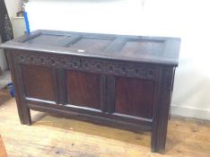 A late 17th/early 18th century oak three-panel coffer, the three-panel cover over thumb-carved