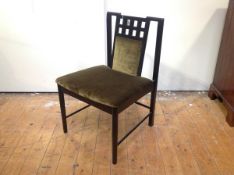 An ebonised side chair in the manner of Charles Rennie Mackintosh, the partially upholstered back