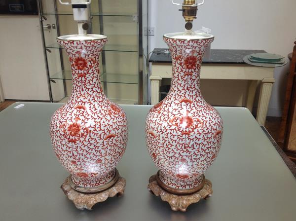 A pair of porcelain baluster vasiform table lamps, each decorated in the Chinese taste with coral
