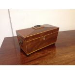 A Regency boxwood strung mahogany sarcophagus tea caddy, the cover with shaped loop handle,