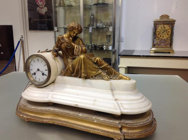 A French 19th century gilt-metal and alabaster mantel clock, the drum head white enamel dial applied