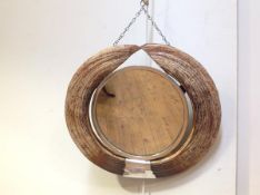 A Hippopotamus tusk mirror, c. 1930/40, the circular plate within a white metal slip, framed by a