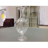 A 19th century acid-etched glass ewer, of slender baluster form, with elongated neck and loop handle
