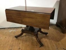 A George IV mahogany sofa table, of characteristic form, with twin leaves, raised on a boldly turned