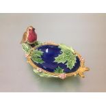 A Minton majolica nut dish, c. 1870, oval, moulded with holly leaves, a robin perched on the rim,