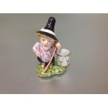 An English porcelain Mansion House dwarf figure, unmarked, modelled standing with a staff, a drum at