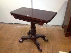 A William IV mahogany foldover card table, the D-shaped top with bead and reel carved edge, on a