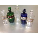 A group of five late 19th/early 20th century coloured and clear glass pharmacy jars comprising: a