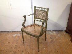 A green-painted canework fauteuil highlighted with gilding, the rectangular back above a bowed