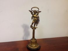 An Edwardian gilt-brass door stop, the lead-weighted base below a figure of Cupid and with loop