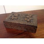 A Chinese camphor-lined carved wooden cigarette box, c. 1900, of rectangular form, the cover and