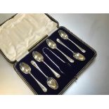 A set of six Sheffield silver shell terminal coffee spoons complete with set of tongs, in original