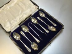 A set of six Sheffield silver shell terminal coffee spoons complete with set of tongs, in original