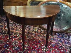 A 19thc mahogany demi lune side table with crossbanded and boxwood strung border and plain frieze,