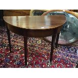 A 19thc mahogany demi lune side table with crossbanded and boxwood strung border and plain frieze,