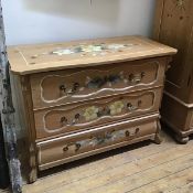 A decorative late 19thc Swiss pine painted commode, the shaped top with handpainted floral sprays