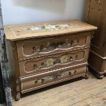 A decorative late 19thc Swiss pine painted commode, the shaped top with handpainted floral sprays