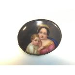 A 19thc Continental oval enamelled porcelain Vienna style brooch depicting a mother and child (5cm x