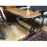 A Victorian walnut sofa table, the shaped top with moulded edge raised on twin end carved shaped