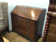 A George III mahogany bureau, the plain top above a fall front enclosing a fitted interior above