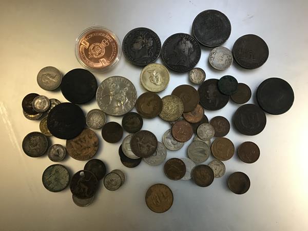 A collection of miscellaneous coins including a George III crown, a Victorian crown, a Queen