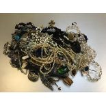 A large collection of costume jewellery including guard chain, 9ct gold studs, paste pearls,