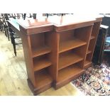 A reproduction yew wood breakfront bookcase, the crossbanded top above a centre open shelf