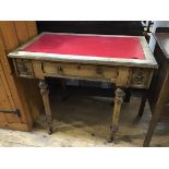 An Edwardian oak writing table, the rectangular top with inset vinyl skiver above a centre frieze