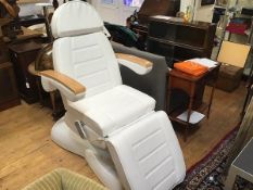 A modern oak framed electrically adjustable fully reclining massage and therapy chair upholstered in