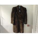 A lady's 1930s vintage three quarter length fur coat with raised collar and single button, with