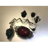 A collection of white metal jewellery mounted with green glass including rings, pendant, red glass